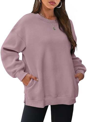 Cut in a dusty dark pink knit with a warm fleece lining, this relaxed crewneck pullover features subtle side slits and hidden pockets.