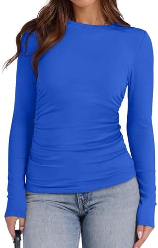Side ruching gathers along the hips of this deep blue long sleeve top, cut in a soft stretch knit.