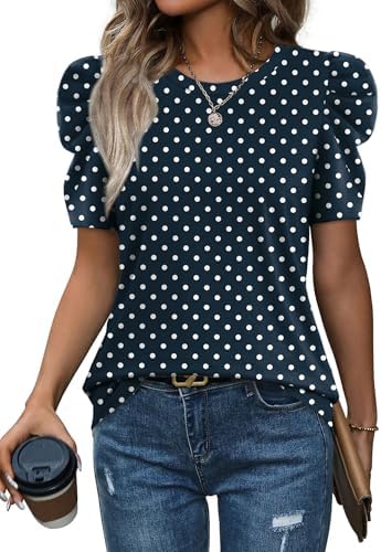 Crisp white dots on deep navy ground this soft summer blouse, finished with shaped leg-of-mutton short sleeves.