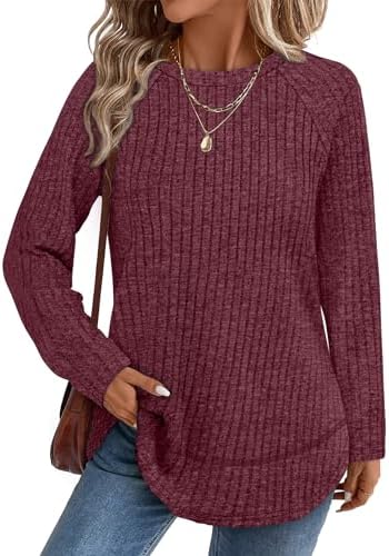 A vivid fuchsia tunic top cut with a curved high-low hem and side slits for easy movement on cool evenings.