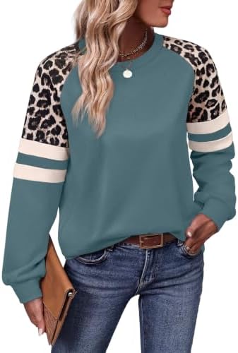 Patterned sleeves in warm leopard print balance the muted cadet blue body of this relaxed, hip-covering crewneck top.