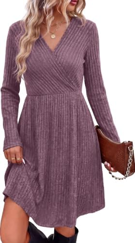 Ribbed knit in a saturated purple shade shapes this knee-length A-line dress with long sleeves and discreet side pockets.