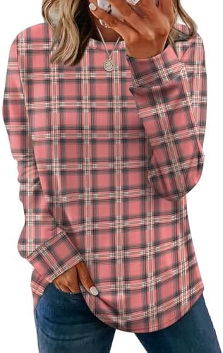 A soft crewneck tunic sweater in warm pink plaid, cut long through the hem with subtle side slits for easy layering over leggings.