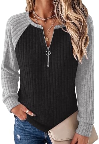 A graphic grey and black paneled knit brings sporty lines to this lightweight ribbed tunic with a ring-pull quarter zipper.