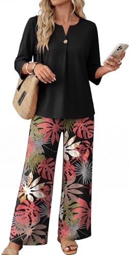 Tropical pink foliage against black grounds this two-piece set, cut with three-quarter sleeves and flowing wide-leg pants.