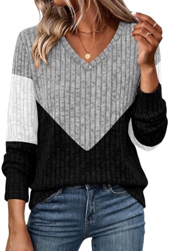 A soft ribbed knit combines cool grey with crisp black panels on a long tunic cut made for easy layering over dark denim or leggings.