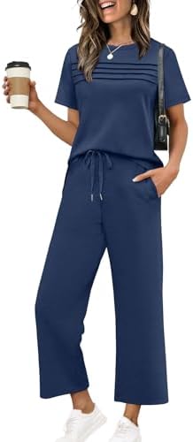 Soft spacer knit pairs a pleated short sleeve top with cropped wide leg pants in deep navy blue.