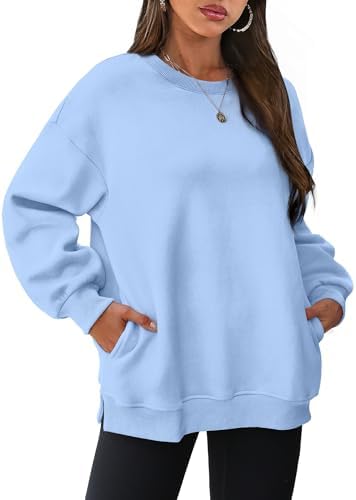 A soft sky blue pullover lined with light fleece, finished with side slits and hidden inseam pockets for easy warmth.