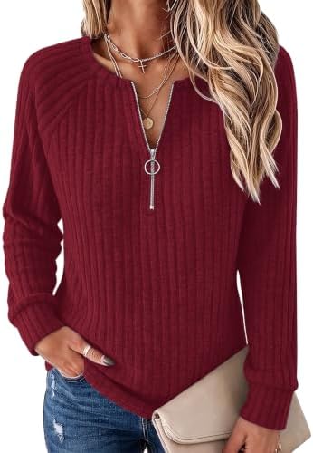 A deep burgundy red ribbed knit tunic with an adjustable quarter zip collar and comfortable raglan sleeves.